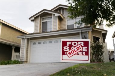 house with sold yard sign house with sold yard sign